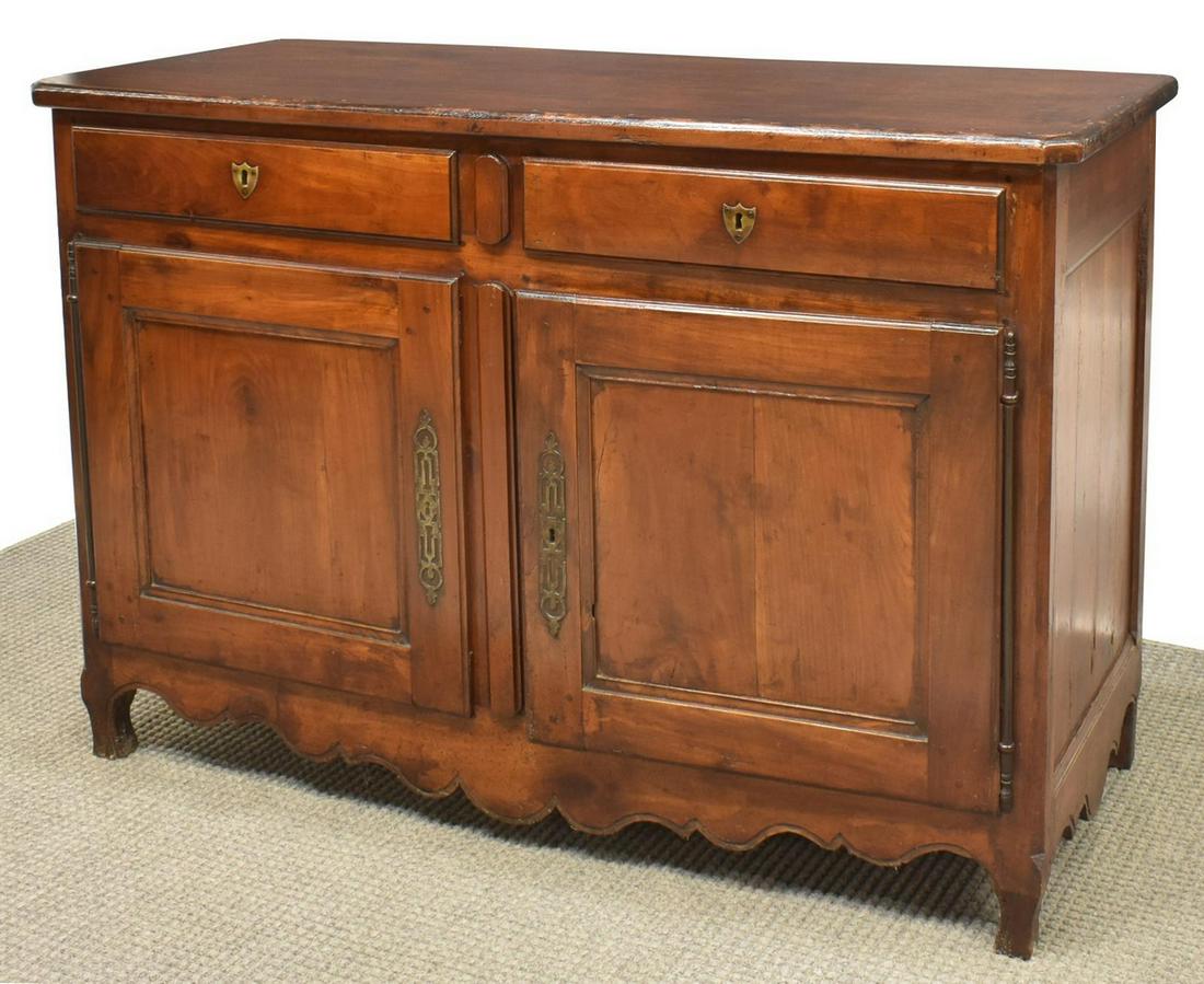 FRENCH LOUIS XV STYLE FRUITWOOD SIDEBOARD: French Louis XV style fruitwood sideboard, late 19th c., the rectangular top having canter corners, above two drawers, each with shield-form escutcheon, paneled doors below open to shelved interior, o
