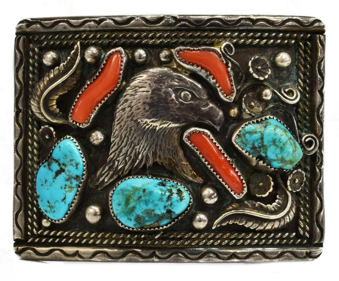 NATIVE AMERICAN SILVER EAGLE HEAD BELT BUCKLE: Native American silver (content unknown) belt buckle, signed RC, eagle's head framed by three turquoise nuggets and red coral pieces, approx 2.25"h, 3"l, 74 grams (inclusive of all materials) Start Pr
