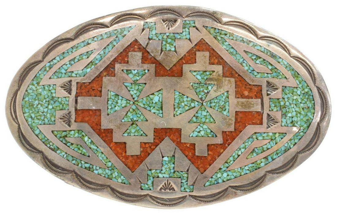 CHARLIE SINGER NAVAJO CHIP INLAY BELT BUCKLE: Native American silver (content unknown) belt buckle, Charlie Singer (Navajo, 1931-2018), geometric turquoise and red coral chip inlay, arrowhead picto hallmark, approx 2.5"h, 4"w, 64.5 grams (inclusi