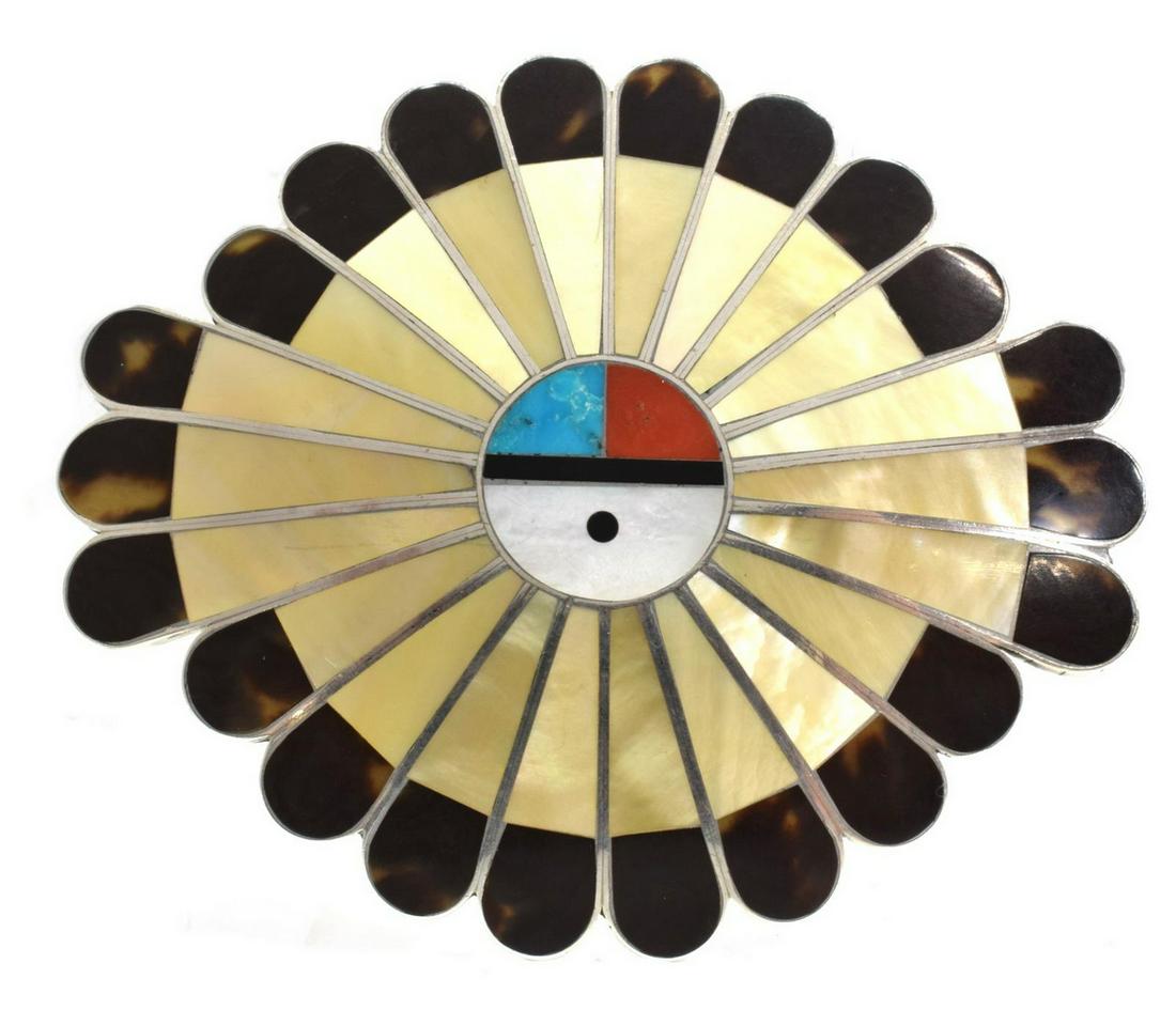 JAY IULEA ZUNI MULTI-STONE INLAY SUNFACE BUCKLE: Native American Zuni silver (content unknown) belt buckle, Jay Iulea, sunface inlaid with turquoise, red coral, mother of pearl, and shell, approx 2 7/8"h, 3.5"w, 58 grams (inclusive of all materials)