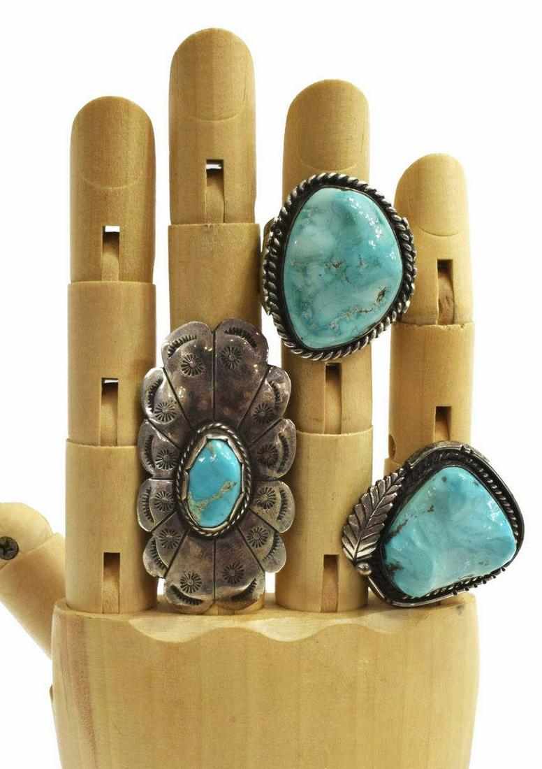 (3) NATIVE AMERICAN SILVER & TURQUOISE RINGS: (lot of 3) Native American silver (content unknown) and turquoise rings, including: (1) central bezel-set turquoise stone with feather motif, approx size 7; (1) oval shaped, bezel-set turquoise stone,