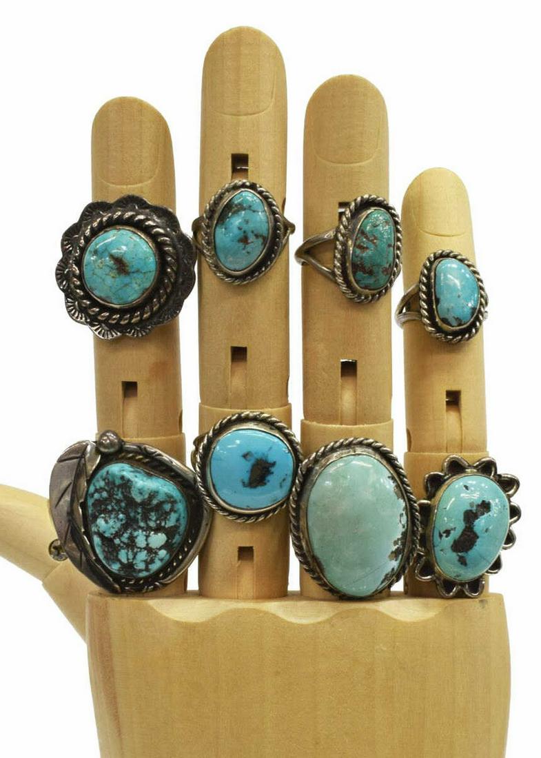 (8) NATIVE AMERICAN SILVER & TURQUOISE RINGS: (lot of 8) Native American silver (content unknown) rings, each with central bezel-set turquoise stone, including: (1) with feather accent, (7) with twisted wiring, (2) radiating petal-form, sizes ran
