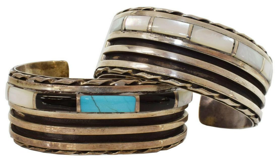 (2) NATIVE AMERICAN SILVER RIBBED & INLAID CUFFS: (lot of 2) Native American silver (content unknown) cuff bracelets, likely Zuni, each with ribbed design, inlaid mother of pearl, and stamped trim, comprising: (1) with central inlaid turquoise stone,