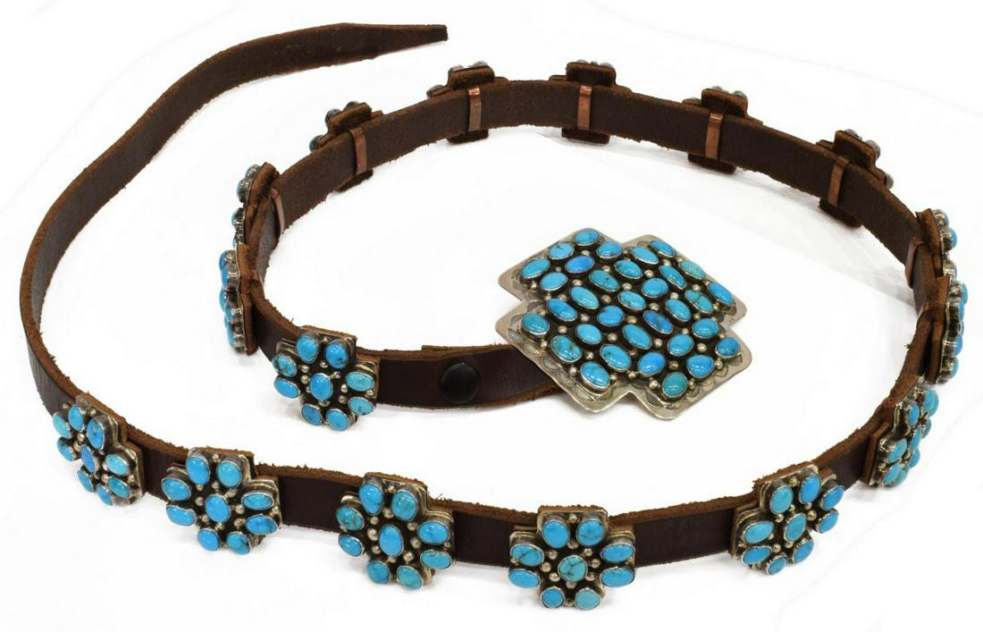 DANIEL MARTINEZ NAVAJO TURQUOISE CONCHO BELT: Native American sterling silver concho belt, signed DM (Daniel Martinez, Navajo, 20th c.), leather strap fitted with (1) buckle and (16) matched conchos, each in cross-form, with cluster of turquoise 