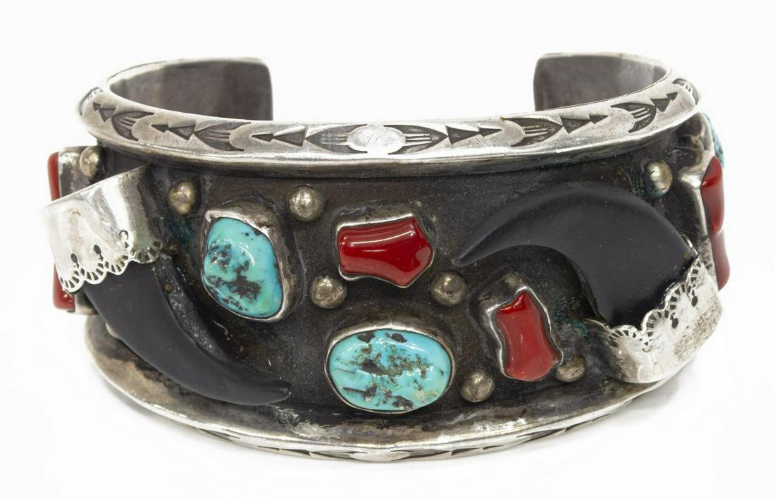 ALBERT PLATERO NAVAJO LES BAKER SHOP SILVER CUFF: Native American silver (content unknown) coral and faux bear claw cuff bracelet, signed Albert Platero (Navajo, 20th c.), shop hallmark for Les Baker (1935-2014) Workshop, arrow borders, bead and feat
