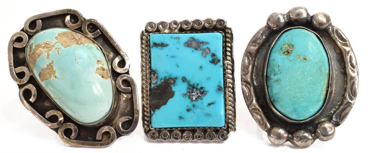 (3) NATIVE AMERICAN STERLING & TURQUOISE RINGS: (lot of 3) Native American silver (content unknown) rings, comprising: (1) central oval bezel-set turquoise cabochon, in stamped and silver beaded frame, approx size 6.75; (1) stamped TP, with central