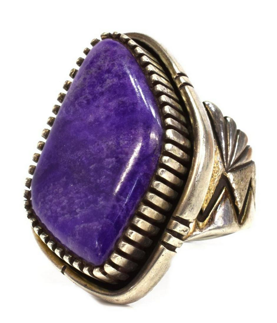 TONEY MITCHEL NAVAJO STERLING SILVER STONE RING: Native American sterling silver ring, Toney Mitchell (Navajo, 20th c.), having bezel set stone, possibly purple sugilite, on worked frame and shank, approx size 14.5, 29 grams (inclusive of all materi