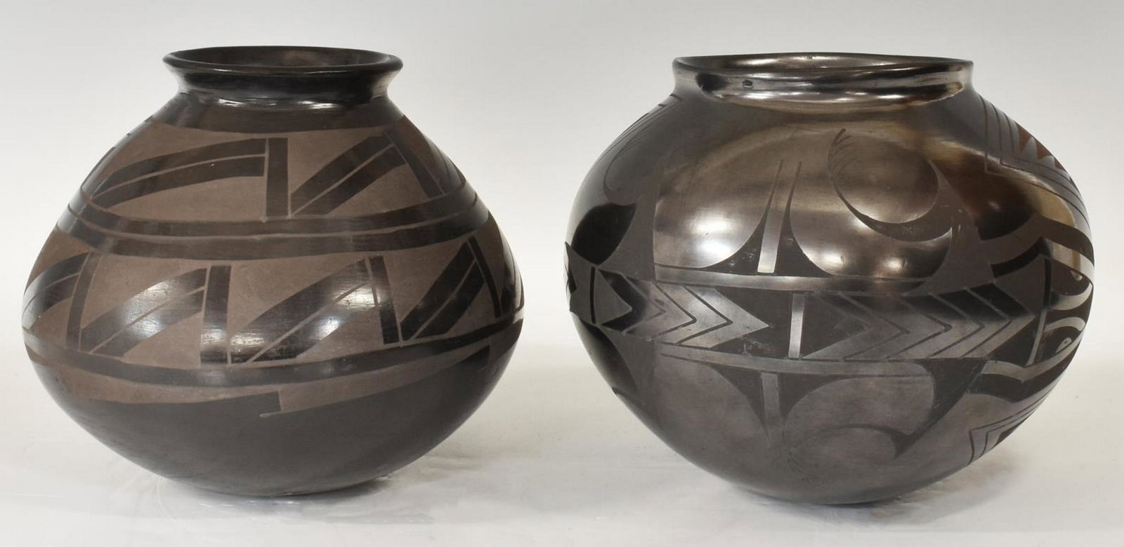 (2) MATA ORTIZ MEXICO POTTERY, JESUS PENA: (lot of 2) Mata Ortiz pottery, Mexico, including: (1) signed Jesus Pena, approx 7"h, 7.25" diam; (1) with lizard decoration, signed Joel, chip at underside of rim, approx 7"h, 7.75"diam Start Price: $