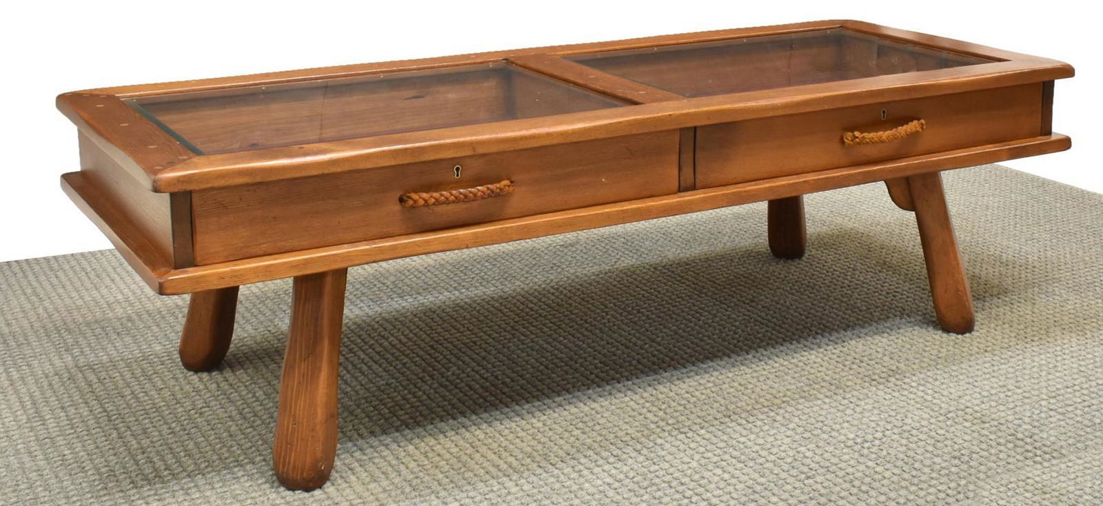 W.R. DALLAS GLAZED PINE DISPLAY COFFEE TABLE: American pine display table, W.R. Dallas Furniture, 20th c., rectangular top with two beveled glass insets, two drawers with braided leather pulls, rising on spoke legs, approx 18"h, 60"w, 24"d **Prov