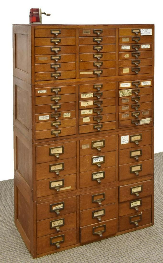 AMERICAN OAK LIBRARY CARD CATALOG/ TOOL CABINET: American oak card/ file catalog or tool cabinet, early 20th c., later painted top with Boston pencil sharpener, case fitted with a variety of small drawers, case: approx 53.25"h, 33"w, 17"d **Provenan