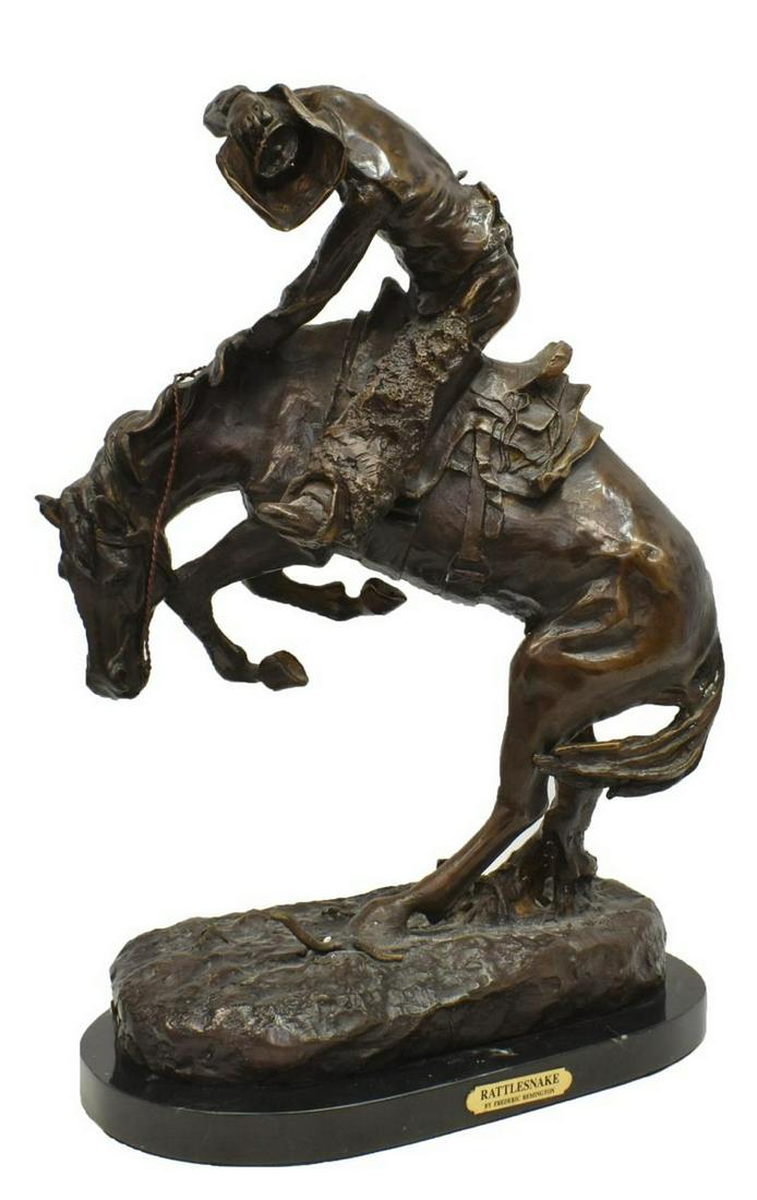 AFTER REMINGTON BRONZE 'THE RATTLESNAKE,' 22"H: Bronze sculpture on marble, "The Rattlesnake," after the original by Frederick Sackrider Remington (American, 1861-1909), Remington copyright 1905, overall: approx 22 "h, 15"w, 8.75"d, 43lbs Start Pri
