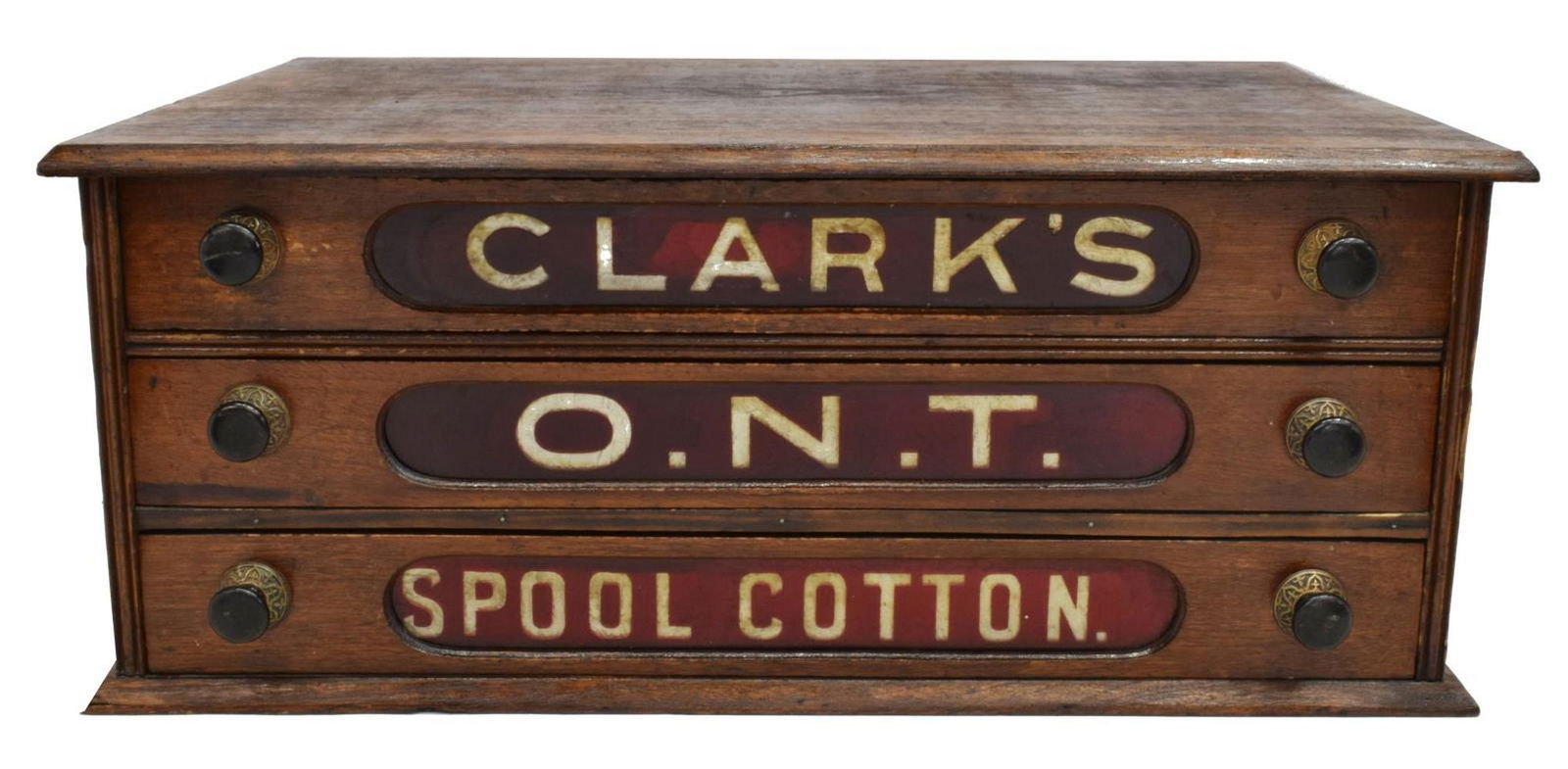 AMERICAN CLARK'S COUNTERTOP OAK SPOOL CABINET: American Clark's countertop oak spool cabinet, late 19th c., three drawers with red foil-backed insets, molded plinth base, approx 9.5"h, 23"w, 16.5"d **Provenance: From the estate of Dr. James R. Luc
