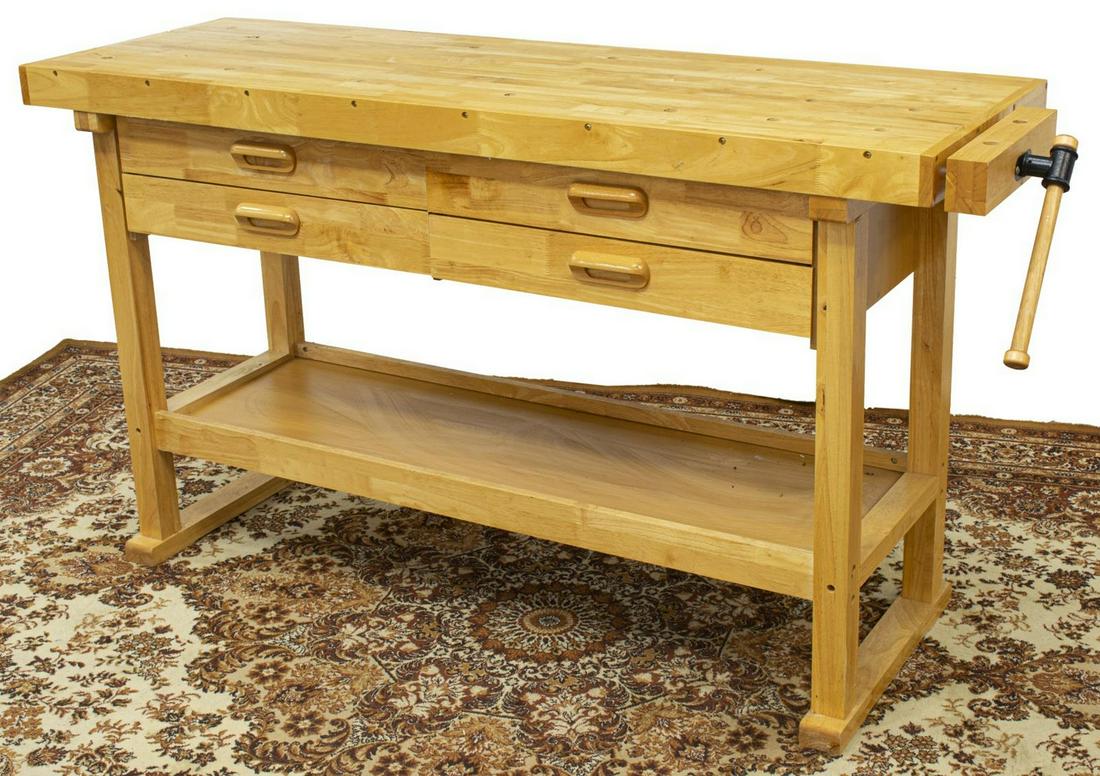 RUSTIC CRAFTSMAN'S WOOD WORKBENCH TABLE: Rustic craftsman's workbench, having rectangular top, with dog holes, four drawers, iron crank vise, raised on trestle base joined by medial shelf, approx 34"h, 64"w, 20"d **Provenance: From the estat