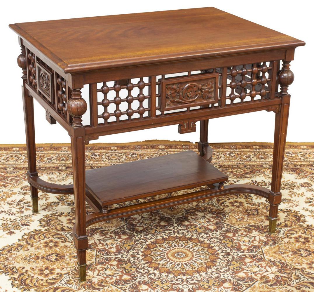 AMERICAN VICTORIAN CHERRY STICK & BALL TABLE: American Victorian cherry table, late 19th/ early 20th c., rectangular top, stick and ball work apron, with foliate carved panels, rising on square tapered legs, joined by medial shelf, ending in bras