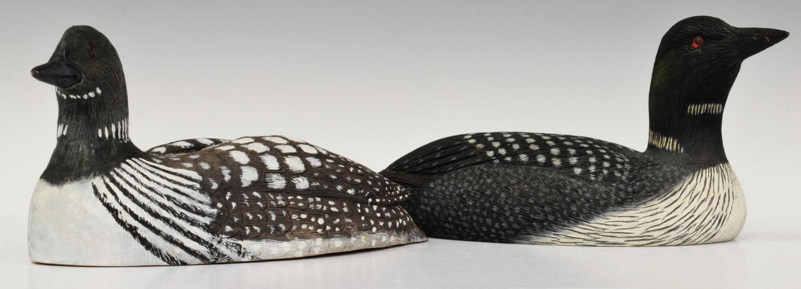 2)GREG DAISEY & LORRY HUESTED AMERICAN LOON DECOYS: (lot of 2) Carved and painted American loon decoys, including: (1) signed Greg Daisey, Chincoteague, Virginia, approx 3"h, 7"w, 3"d, (1) signed Lorry Huested (b.1937), Am. Loon, dated January 1993, Wh
