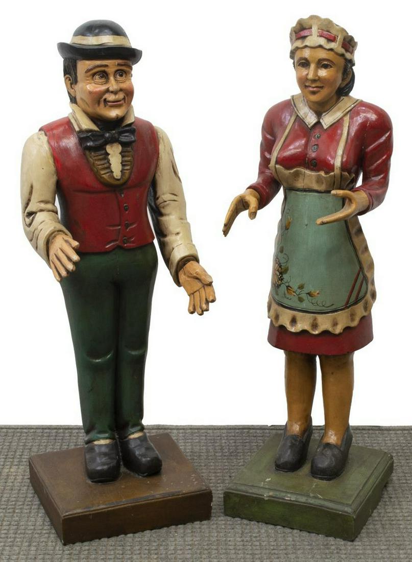 (2) CARVED & PAINTED BUTLER & MAID DUMB WAITERS: (lot of 2) Carved and painted dumb waiters, 20th c., with inset eyes, detachable hands, standing on a plinth base, including: (1) butler in bowler hat, (1) maid, largest - approx 41"h, 11.5"w, 12"d **