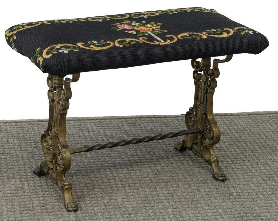 VICTORIAN NEEDLEPOINT SEAT CAST IRON PIANO BENCH: Victorian piano bench, late 19th c., needlepoint-covered seat, over cast iron base with remnants of gilt paint, ending in paw feet, approx 17.5"h, 25.5"w, 12.5"d **Provenance: From the estate of Dr. J