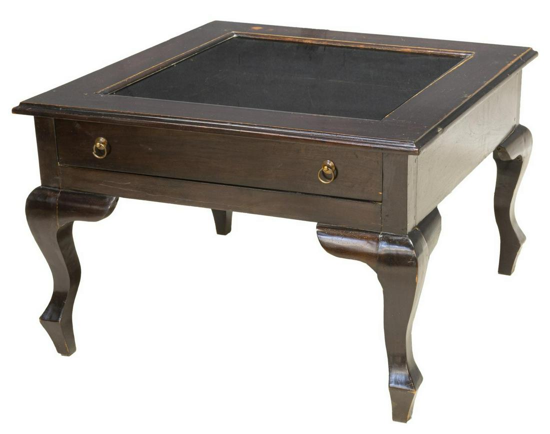 LACQUERED GLAZED TOP DISPLAY TABLE: Display table, 20th c., finished in worn dark brown lacquer, rectangular with an insert glass top over a single display drawer, rising on shaped supports, approx 21"h, 31.5"w, 31"d Start Price: $30.00