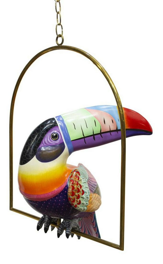 SERGIO BUSTAMANTE (B.1942) TOUCAN SCULPTURE: Painted papier-mache sculpture, Toucan, signed Sergio Bustamante (Mexican, b.1942/ 1943), A.P. (artist's proof), on brass hanging perch, toucan: approx 17"h, 20.5"w, perch: approx 23.5"h, 21"w (measur