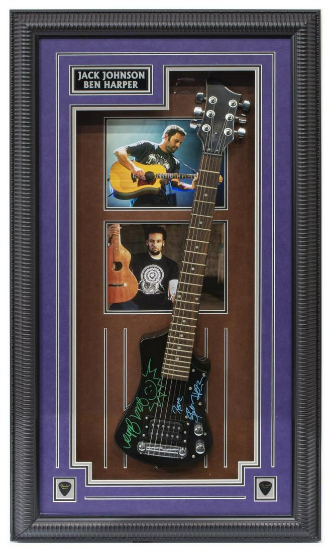 JACK JOHNSON & BEN HARPER SIGNED MINI GUITAR: Jack Johnson and Ben Harper autographed miniature guitar and artist photos, housed in shadowbox frame, tamper evident sticker #118023 provided by Pinpoint Authentication Services, overall: approx 44.2