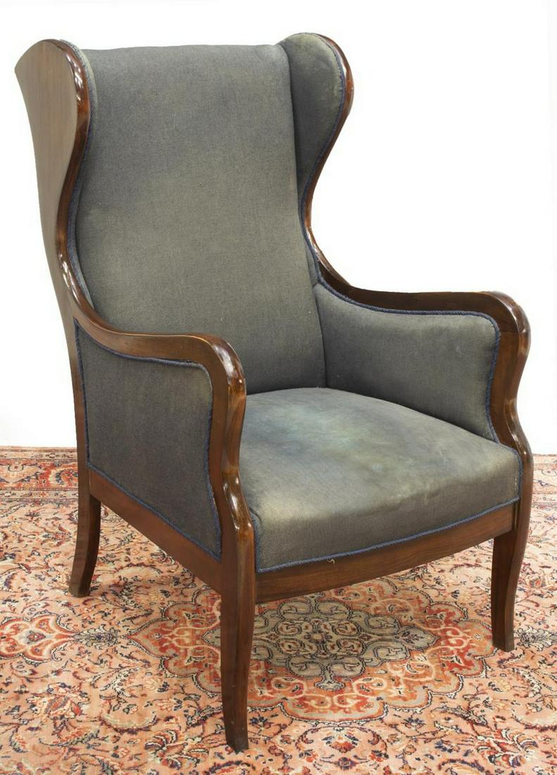 DANISH MAHOGANY FRAME WINGBACK ARMCHAIR: Danish mahogany framed wingback chair, mid 19th c., having dark worn upholstery, rising on saber legs, approx 42"h, 25.25"w, 28"d Start Price: $200.00