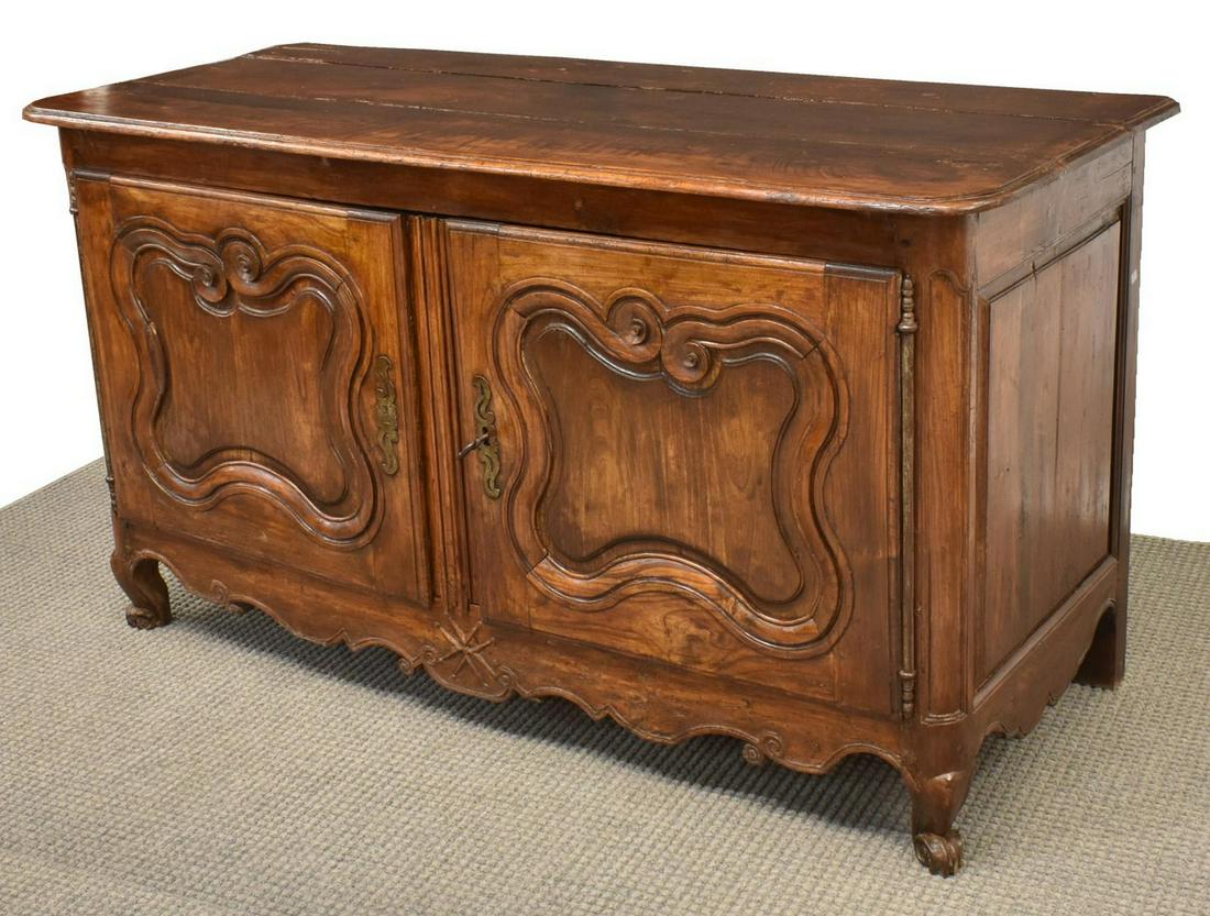 FRENCH LOUIS XV PERIOD WALNUT SIDEBOARD, 18TH C.: French Provincial Louis XV period walnut sideboard, 18th c., having a rectangular top, over two doors, with shaped inset panels, long exposed hinges, pierced scrolling escutcheon, rising on cabriole l