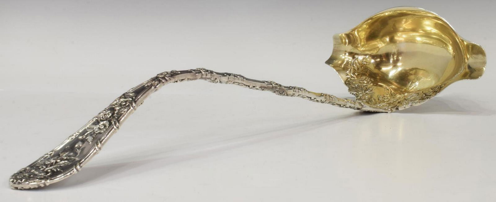 DURGIN 'DAUPHIN' STERLING SILVER PUNCH LADLE: American sterling silver punch ladle, Wm. B. Durgin Co., in the "Dauphin" pattern, reeded handle with vining floral motif, gilt washed bowl, script 'D' mark, not monogrammed, approx 13.5"l, 8.92ozt St