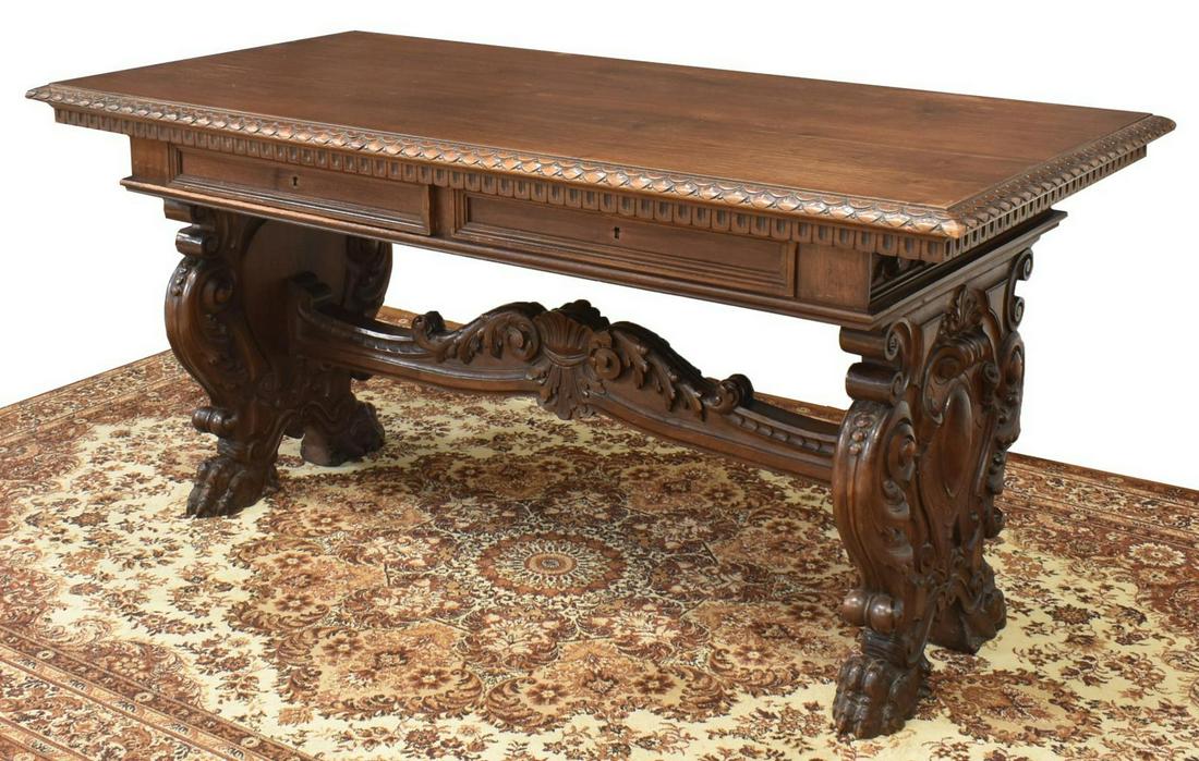 ITALIAN RENAISSANCE REVIVAL CARVED WRITING DESK: Fine Italian Renaissance Revival carved walnut library table/ writing desk, early 20th c., rectangular top over two frieze drawers, elaborately carved with foliate, shell, and scrolled motifs, joined