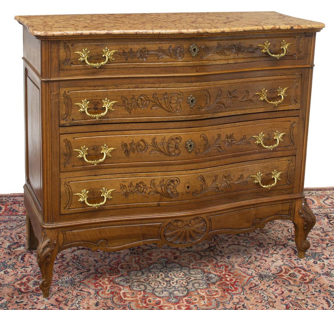 FRENCH LOUIS XV STYLE MARBLE-TOP WALNUT COMMODE: French Louis XV style marble-top walnut commode, 19th c., shaped case, fluted edges, paneled sides, fitted with four drawers, parcel gilt foliate pulls, scalloped and foliate carving throughout, risin