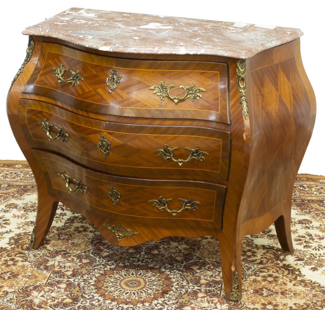 LOUIS XV STYLE MARBLE-TOP BOMBE COMMODE: Louis XV style bombe commode, mid 20th c., having a shaped marble top, diamond matched mahogany veneers, fitted with three drawers, scalloped apron, rising on French bracket feet, ending in sabots, ap