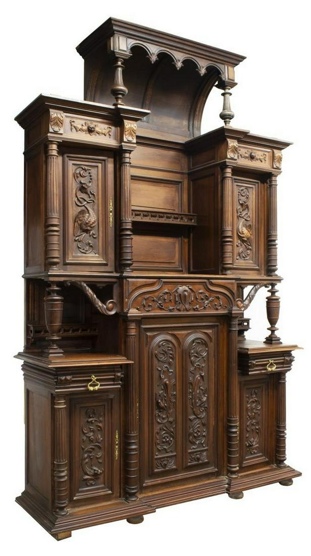 MONUMENTAL RENAISSANCE REVIVAL WALNUT SIDEBOARD: Continental Renaissance Revival walnut sideboard, late 19th c., arched center section, turned and fluted vertical supports, pierced plate rail, flanked by cabinet doors with grotesques in relief, lowe
