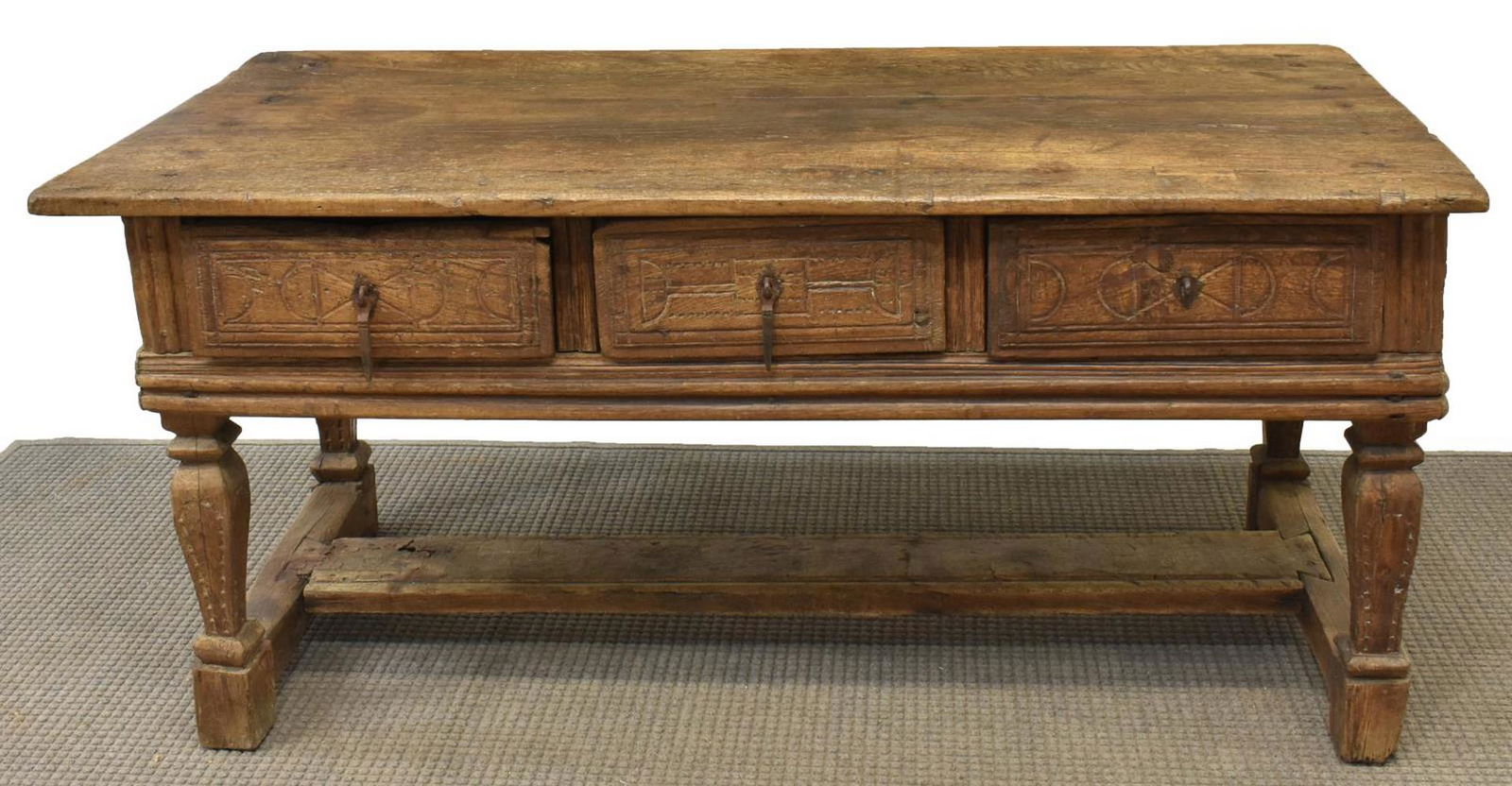 LARGE SPANISH BAROQUE CONSOLE TABLE: Large Spanish Baroque console table, 17th c., rectangular top, over three frieze drawers with iron hardware, all rising on carved legs joined by H stretcher, approx 32"h, 68.25"w, 32"d Start Price: $1