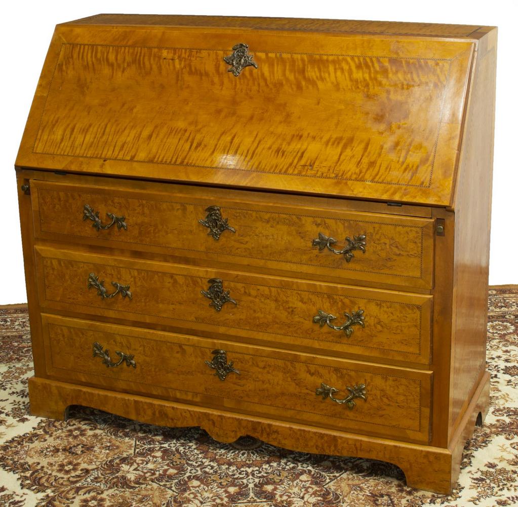 BIEDERMEIER MAPLE SLANT-FRONT SECRETARY DESK: Biedermeier slant-front secretary, 19th c., maple case with geometric string inlay, front panel opening to fitted interior gallery with small drawers, cabinet door, and open niches, desk supported by 