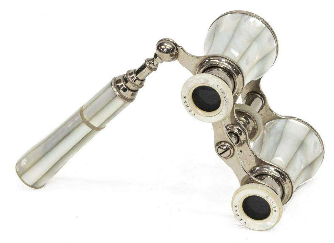 FRENCH VERNE MOTHER OF PEARL OPERA GLASSES: French mother of pearl and silver-tone metal opera glasses, eyepieces marked Verne, Paris, with unassociated pink silk sleeve, approx 4.75"l, 2.75"w (stem closed), 0.75lbs Start Price: $50.00