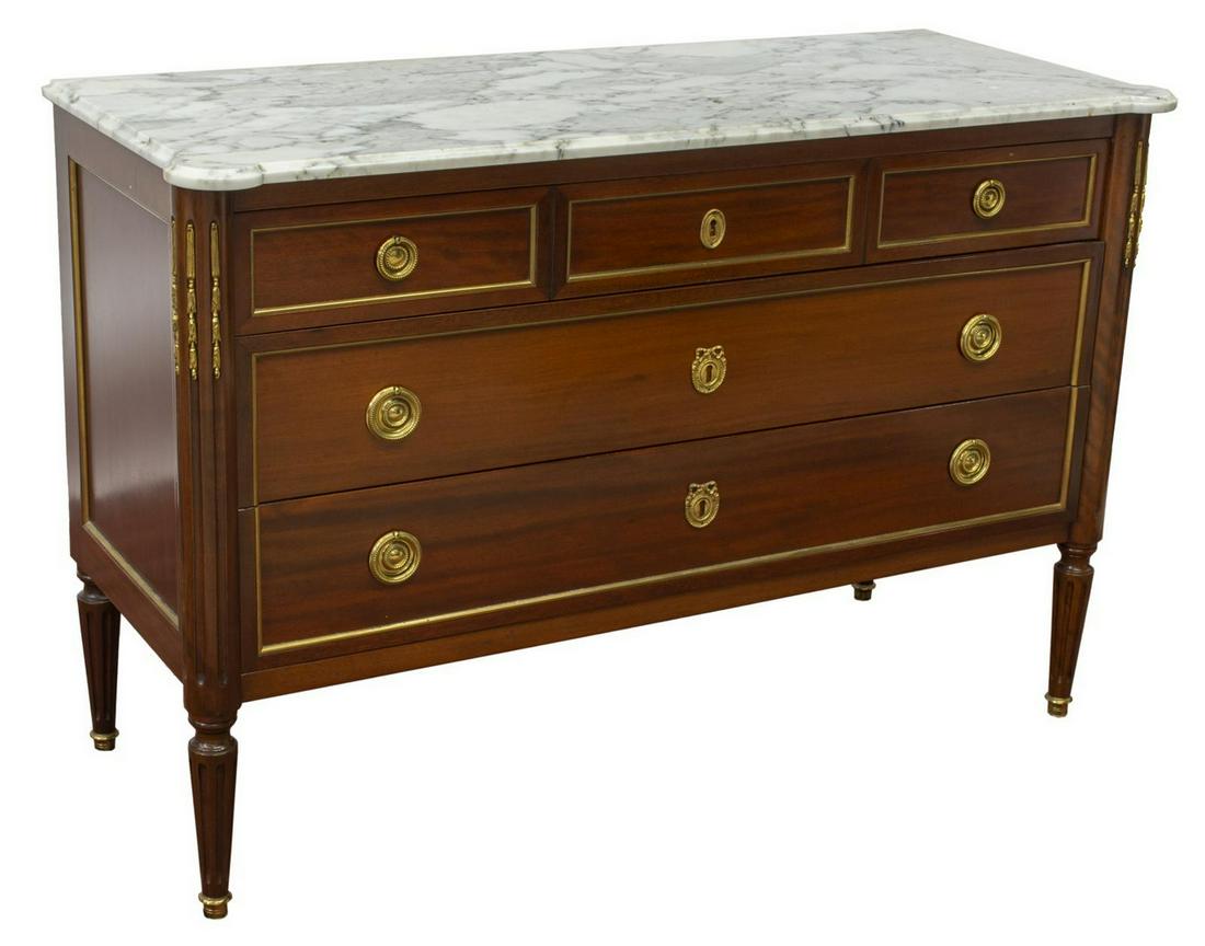 FRENCH LOUIS XVI STYLE MARBLE-TOP MAHOGANY COMMODE: French Louis XVI style marble-top mahogany commode, early 20th c., case fitted with three drawers, fluted sides, parcel gilt accents, beaded pulls, wreath-form escutcheons, rising on fluted tapered le