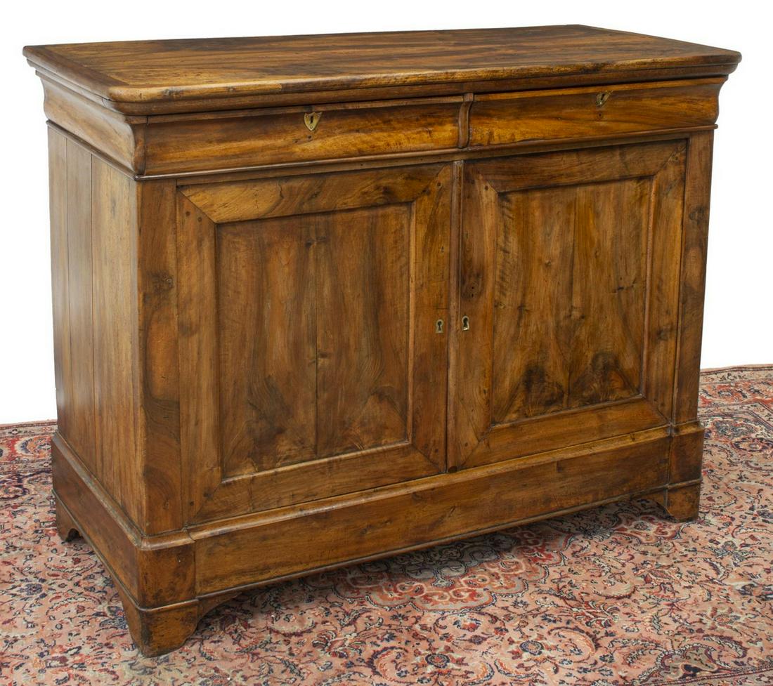 FRENCH LOUIS PHILIPPE PERIOD WALNUT BUFFET: French Louis Philippe period walnut buffet, mid 19th c., having rounded rectangular top, case fitted with two frieze drawers, double-door cabinet with shield-form escutcheons, opening to interior stor