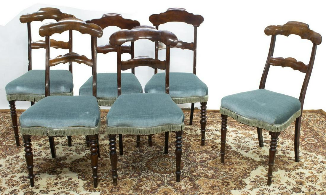 (6) EMPIRE STYLE MAHOGANY DINING CHAIRS: (lot of 6) Empire style mahogany dining chairs, 19th c., shaped top and lower rails, over blue upholstered seat with tassel trim, rising on turned front legs, saber back legs, approx 37.25"h, 17.5"w,