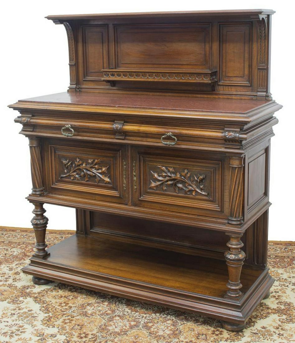 RENAISSANCE REVIVAL MARBLE-TOP WALNUT SERVER: French Renaissance Revival walnut server, late 19th c., paneled back, open shelf on foliate corbels, pierced plate rail, inset marble top, two frieze drawers, two doors with foliate carving, spiral co