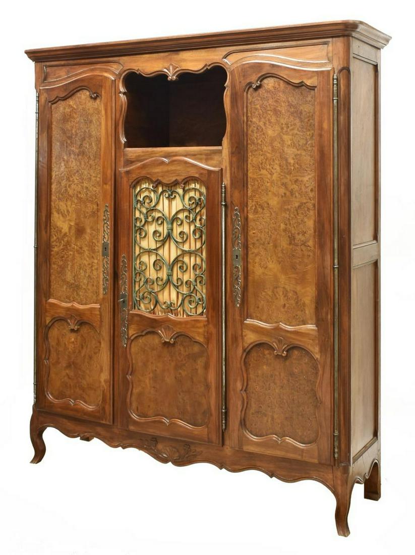 FRENCH LOUIS XV STYLE WALNUT THREE-DOOR CABINET: French Louis XV style walnut cabinet, early 20th c., rounded cornice over rectangular case inlaid with figured burlwood panels, central open niche over cabinet door with wrought iron panel, flanked by