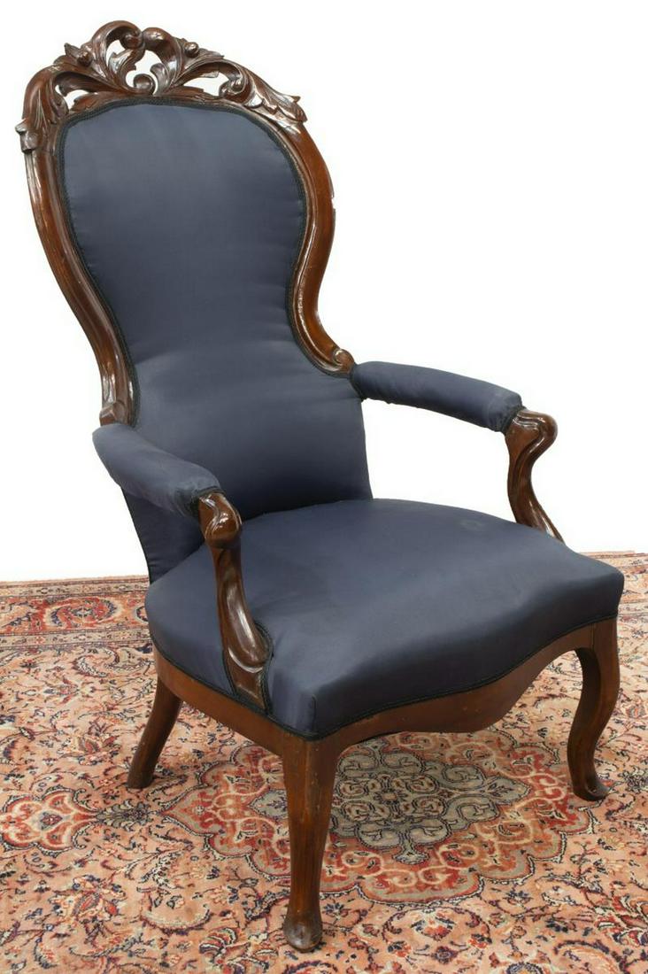 ROCOCO REVIVAL MAHOGANY PARLOR ARMCHAIR: Rococo Revival mahogany parlor armchair, 19th c., carved and pierced crest, in black upholstery, rising on front cabriole legs, approx 45.75"h, 26.5"w, 30"d Start Price: $150.00