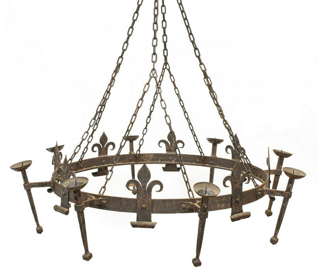 PALATIAL GOTHIC STYLE EIGHT CANDLE CHANDELIER: Palatial Gothic style hammered steel candle chandelier, 20th c., circular structure, supporting eight candle prickets alternating fleur-de-lis, approx 14"h, 52.5"diam (measurements not including chain