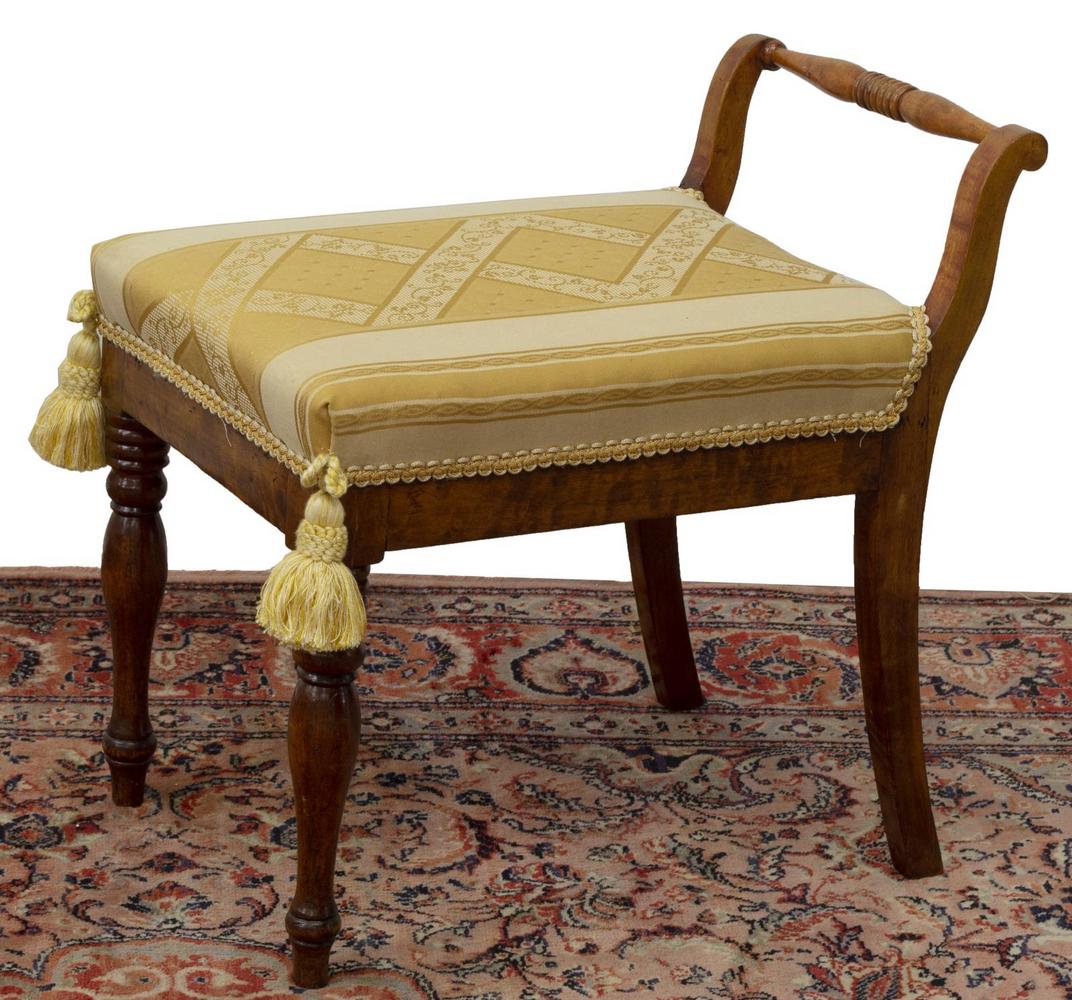 EMPIRE STYLE UPHOLSTERED SEAT BENCH: Empire style bench, having a turned support, cushioned seat with yellow floral upholstery, braided trim and two large tassels, rising on turned and saber legs, approx 21"h, 22"w, 13.75"d Start Price: 