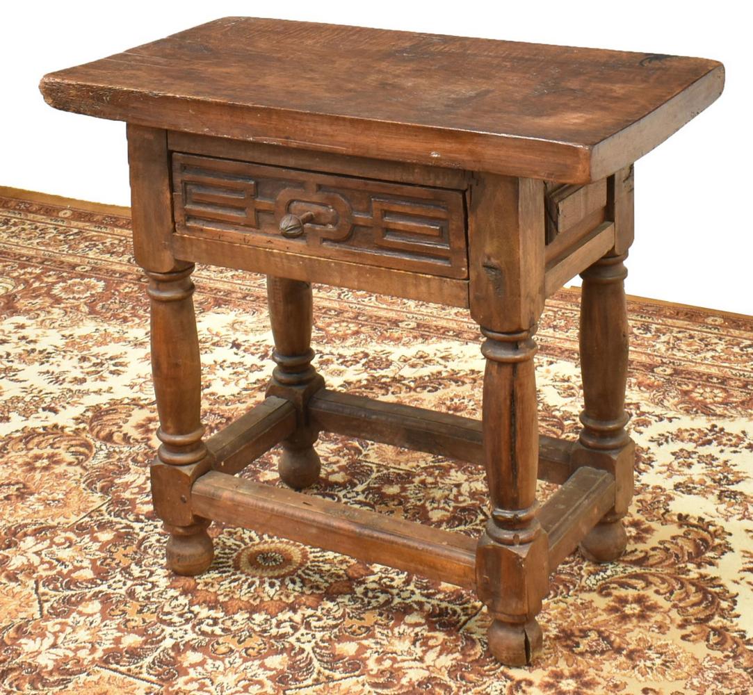SPANISH BAROQUE STYLE OAK SIDE TABLE, 19TH C.: Spanish Baroque style oak side table, 19th c., having a rectangular top, over single carved drawer with metal foliate pull, turned supports, rising on bun feet, wear and loss consistent with age, appr