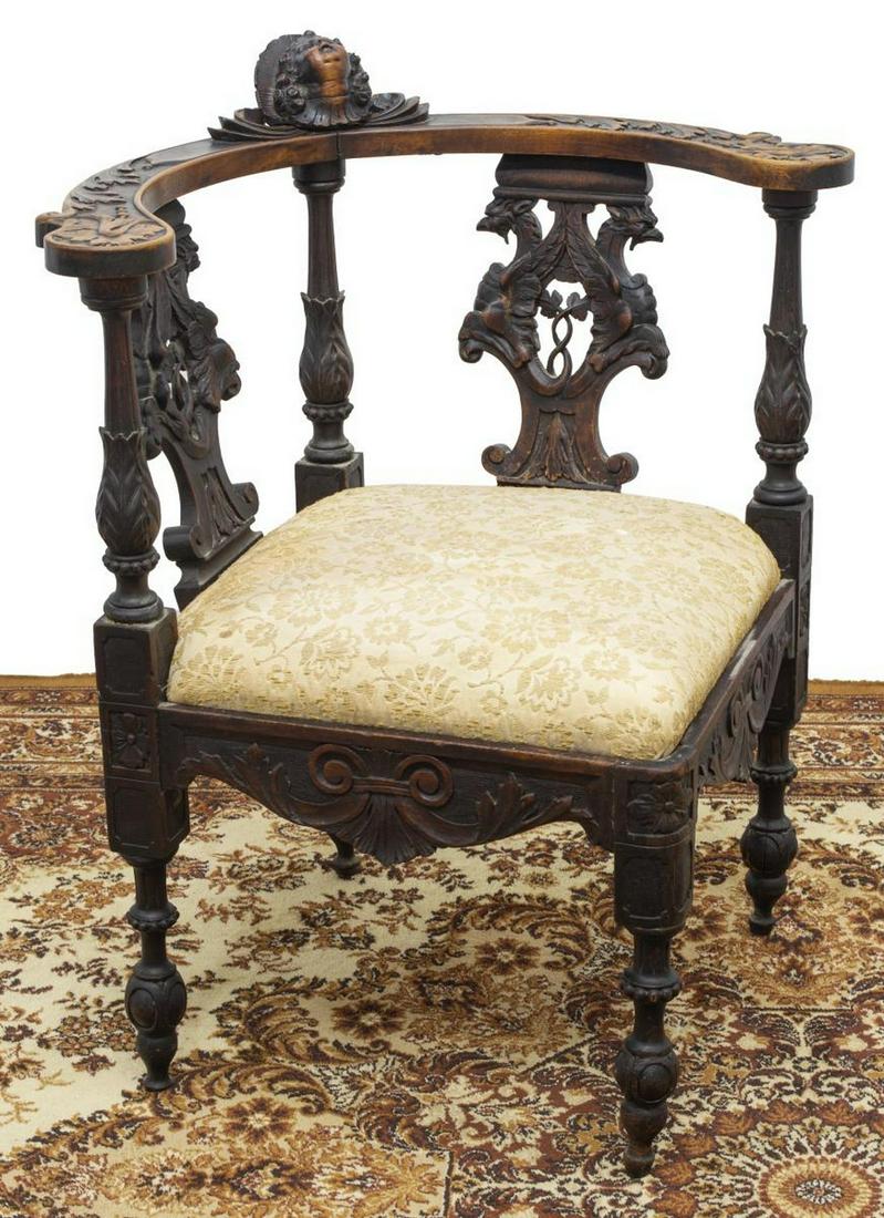 ITALIAN RENAISSANCE REVIVAL CARVED CORNER CHAIR: Italian Renaissance Revival corner chair, late 19th c., shell and cherub crest surmounting rounded back, carved splats with opposing griffins, upholstered seat, rising on turned and carved legs, resto
