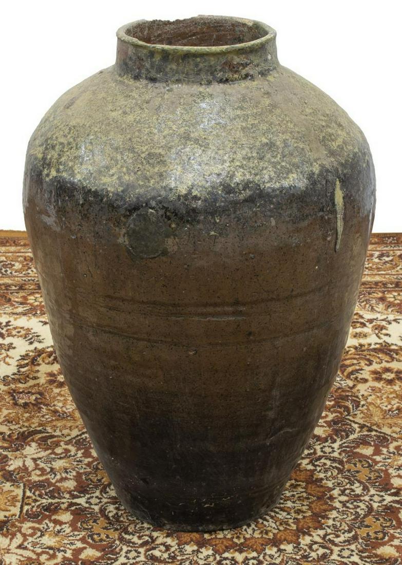 LARGE CHINESE EARTHENWARE RICE WINE CONTAINER: Large Chinese earthenware rice wine container, glazed, having a shaped body, approx 25.5"h, 17"d Start Price: $50.00