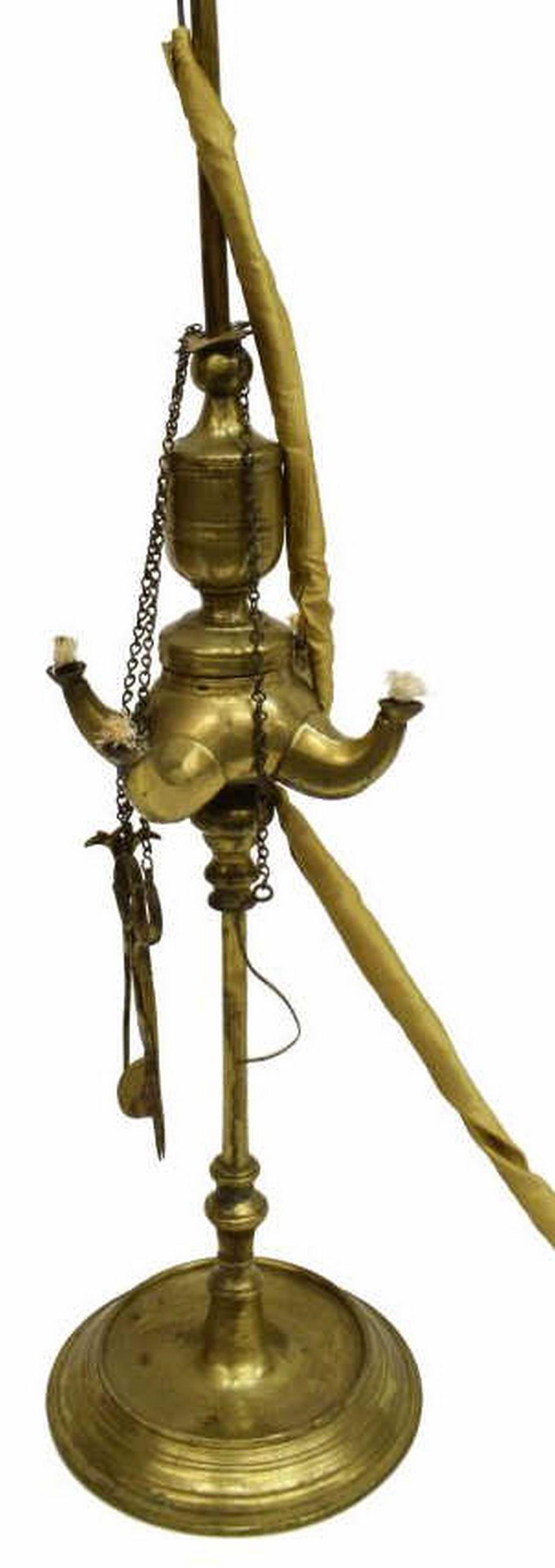 ANTIQUE BRASS WHALE OIL LAMP NOW ELECTRIFIED: Antique brass whale oil lamp, now electrified, having a top finial, lamp shade depicting city scenes of Florence, four spouts with wick trimmer and pick tools on link chain, rising on round base with 