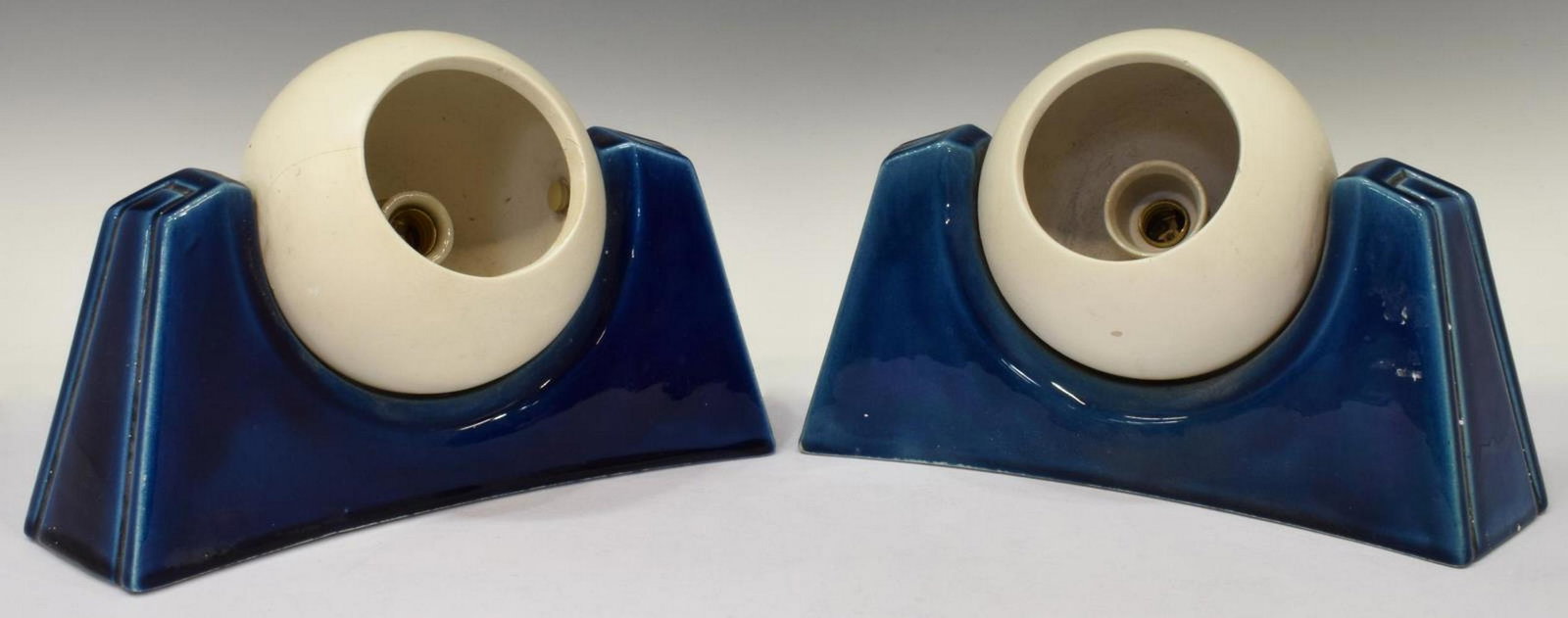 (2) ITALIAN BLUE GLAZED CERAMIC 1-LT WALL SCONCES: (pair) Italian blue glazed ceramic one-light sconces, c.1960s, each having a curved shape, holding adjustable open sphere light, in need of wiring, approx 5"h, 8.5"w, 2.5"d; 3lbs total **Note: matchin