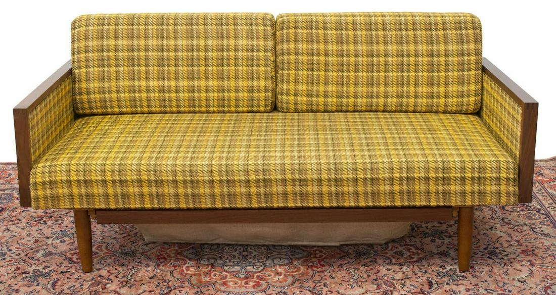 DANISH MID-CENTURY MODERN CONVERTIBLE DAYBED SOFA: Danish mid-century modern teak convertible daybed sofa, c.1960s, having yellow upholstered removable cushions, pull-out cloth basket under seat, on tapered wood legs, approx 30"h, 63"w, 30"d Start Pri