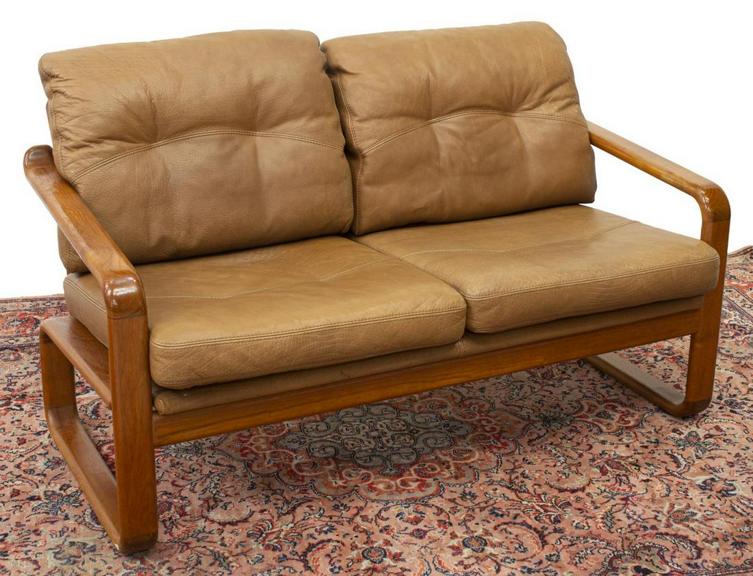 DANISH MID-CENTURY MODERN 2-SEAT TEAK FRAME SOFA: Danish mid-century modern two-seater loveseat/ sofa, c.1960s-1970s, having teak frame, with ladder back, light brown leather removable back and seat cushions, approx 31"h, 52.5"w, 29"d Start Price: $2