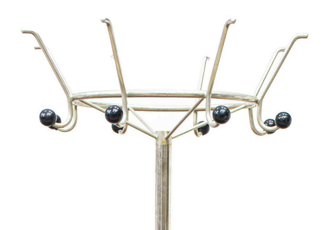 ITALIAN MID-CENTURY MODERN CHROMED HALL TREE: Italian mid-century modern chromed steel hall tree, c.1960s-1970s, having eight arms terminating in hat and coat hooks, cylindrical standard, lower umbrella/ cane rail, on four legs, label reading Ene